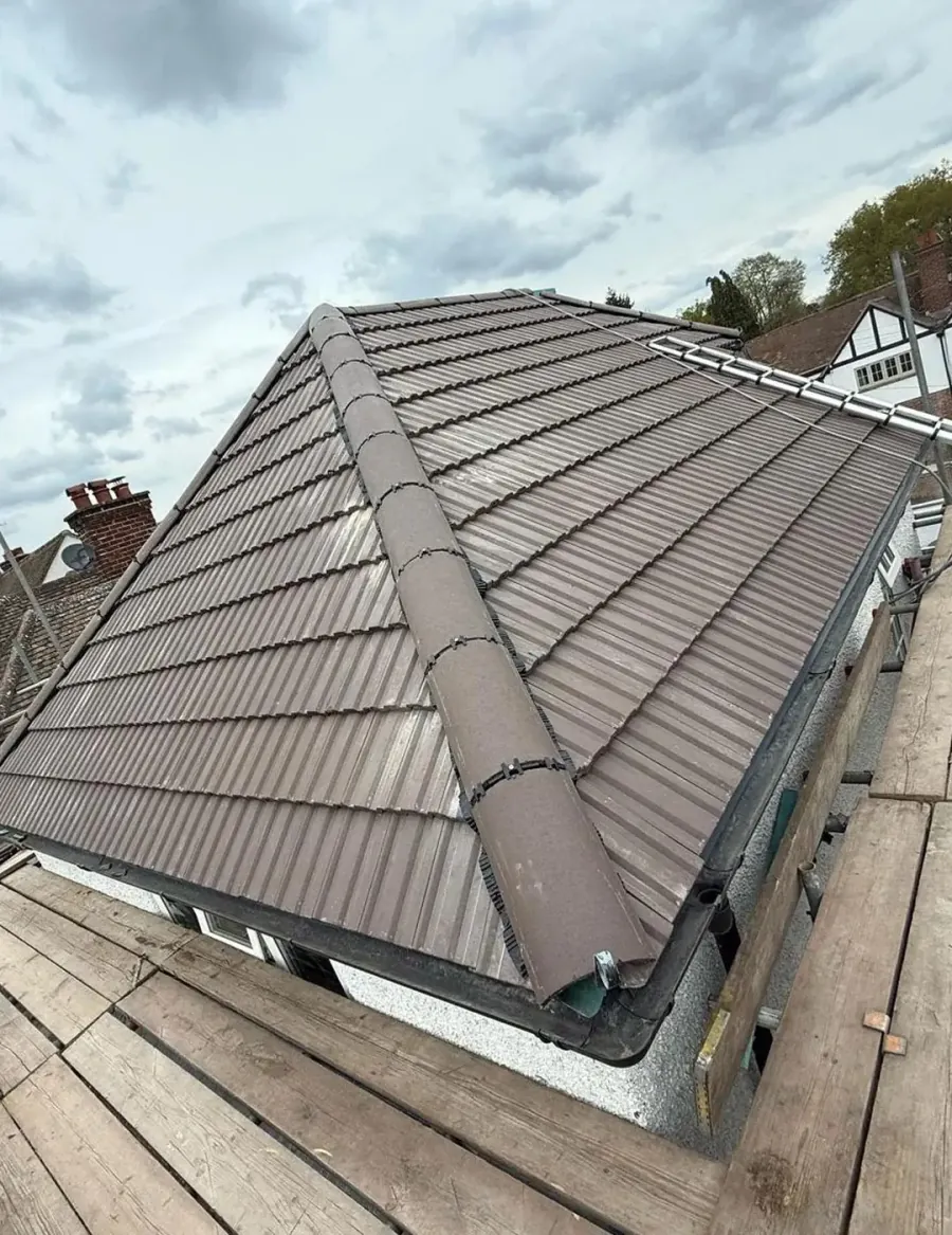 Roofer fitting new tiles during a roof replacement in Berkshire